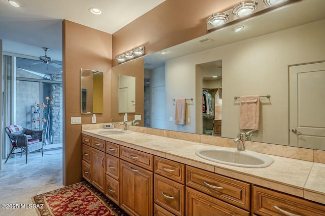 bathroom with ceiling fan and vanity