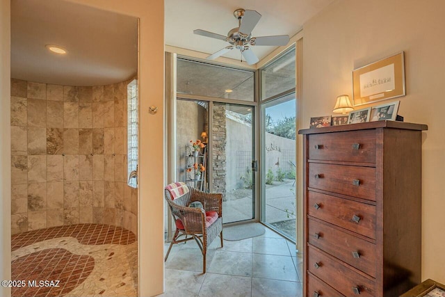 bathroom with ceiling fan, a wall of windows, and tile patterned floors