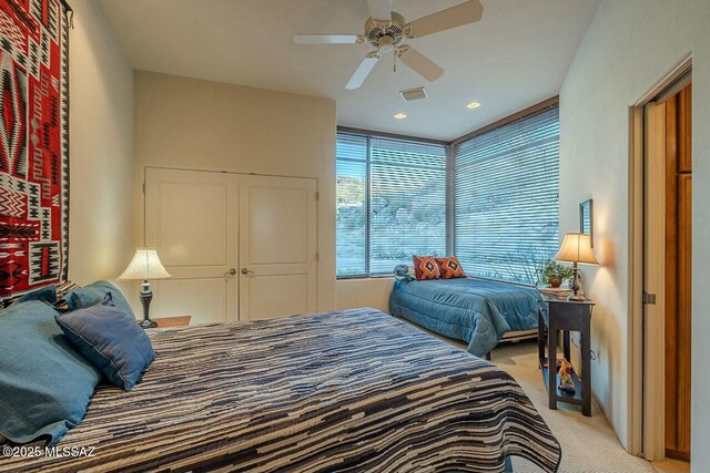 bedroom featuring ceiling fan and light colored carpet