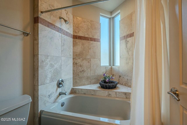 bathroom featuring toilet and shower / bath combo with shower curtain