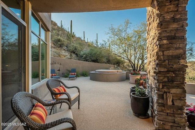 view of patio / terrace with a hot tub