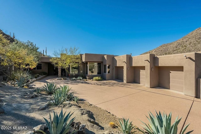 pueblo-style home with a garage