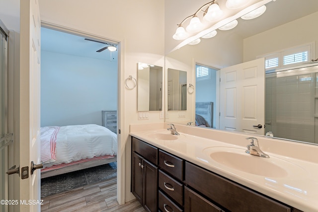 bathroom with vanity, hardwood / wood-style floors, an enclosed shower, and ceiling fan