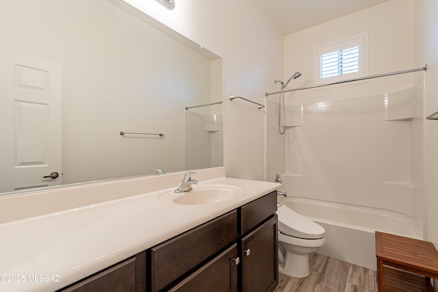 bathroom featuring washtub / shower combination, wood finished floors, toilet, and vanity