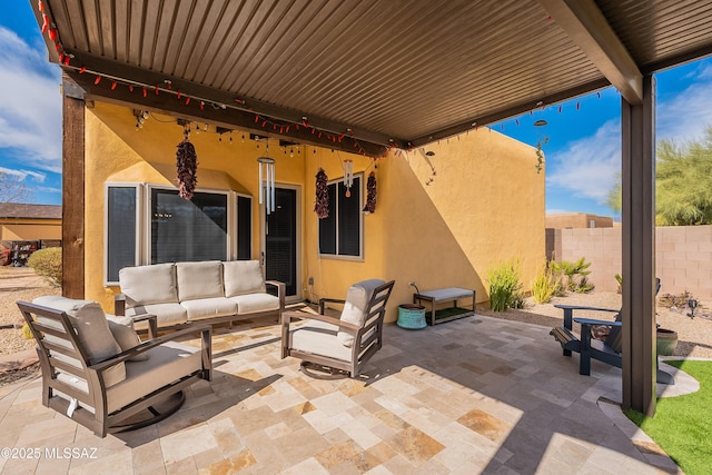 view of patio featuring outdoor lounge area and fence