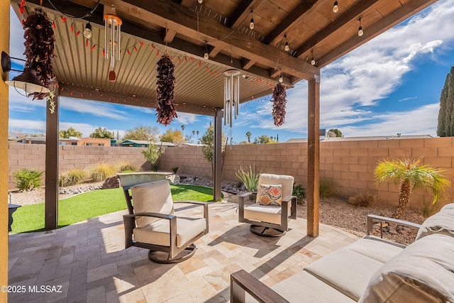 view of patio / terrace featuring an outdoor living space and a fenced backyard