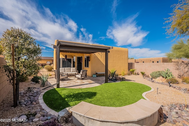 rear view of property with a yard, an outdoor hangout area, and a patio area