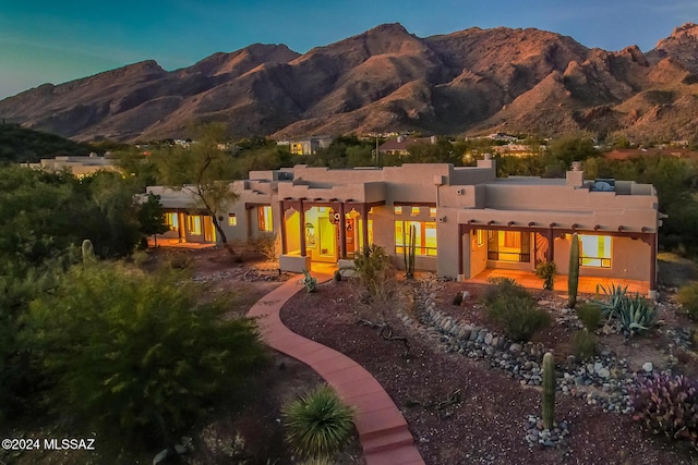 back house at dusk with a mountain view