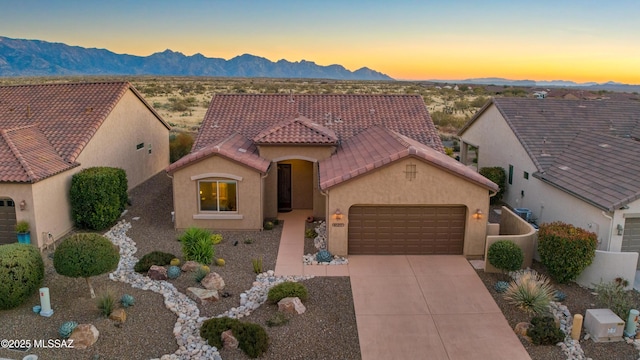 view of front of house with central AC and a mountain view