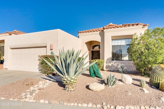 mediterranean / spanish-style home featuring a garage