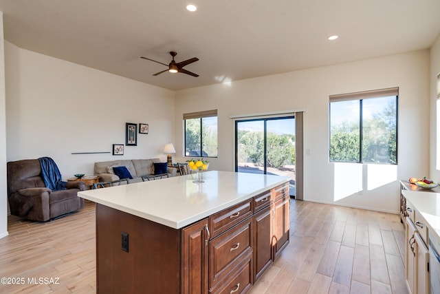 kitchen with a kitchen island, light hardwood / wood-style floors, and ceiling fan