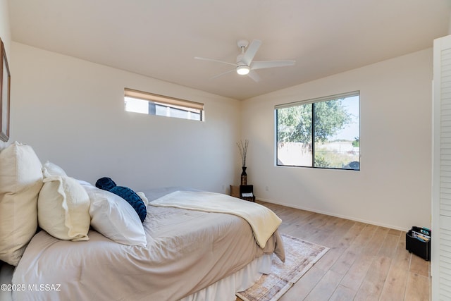 bedroom featuring light wood-type flooring and ceiling fan