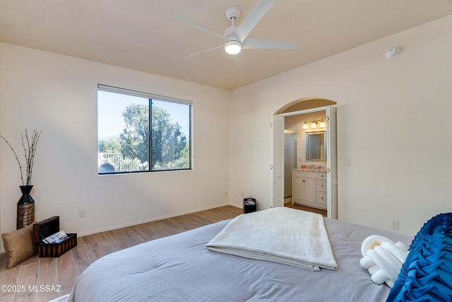 bedroom featuring ceiling fan, hardwood / wood-style floors, and ensuite bathroom