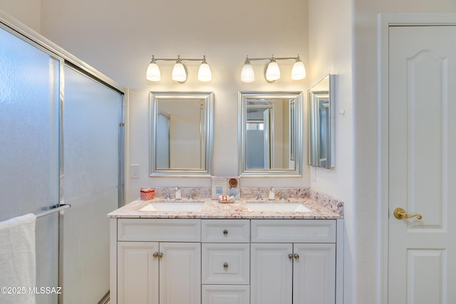 bathroom featuring an enclosed shower and vanity