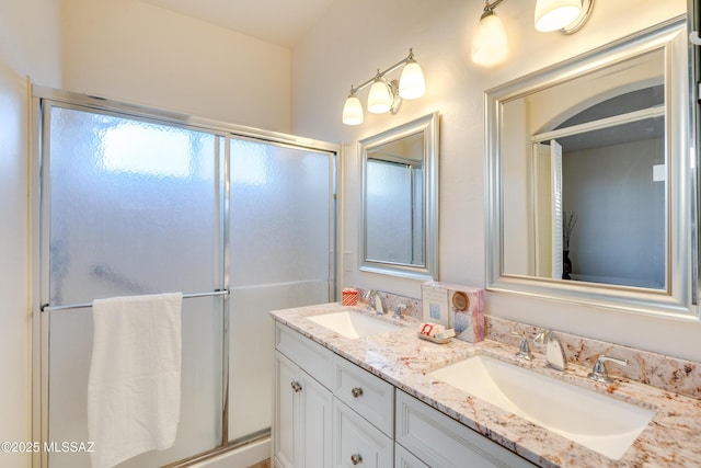 bathroom featuring walk in shower and vanity