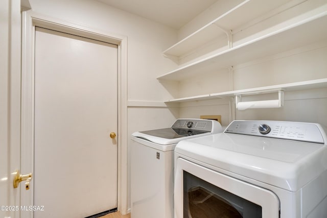 clothes washing area with independent washer and dryer