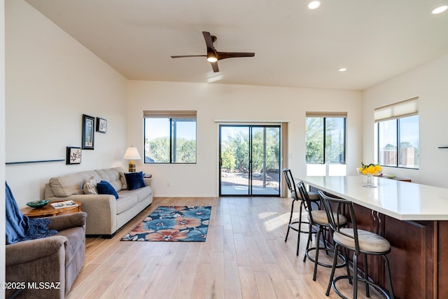 living room featuring ceiling fan and light hardwood / wood-style flooring