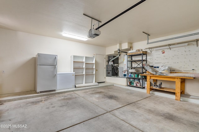 garage with a garage door opener and white fridge