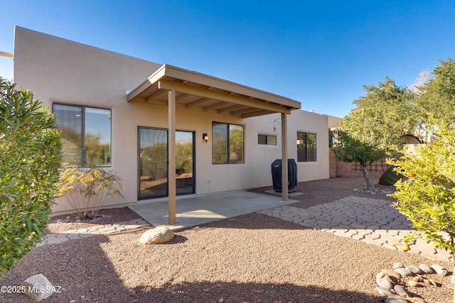 rear view of property featuring a patio area