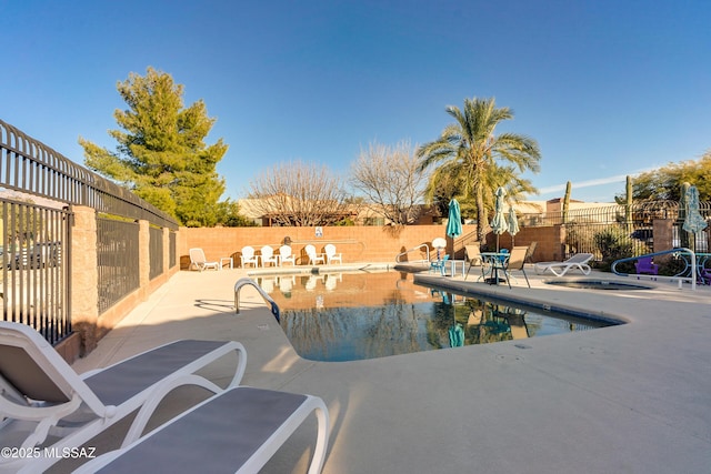 view of swimming pool featuring a patio area