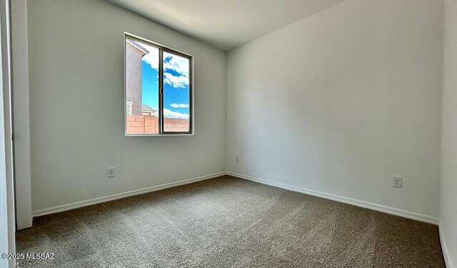 spare room with carpet floors and baseboards