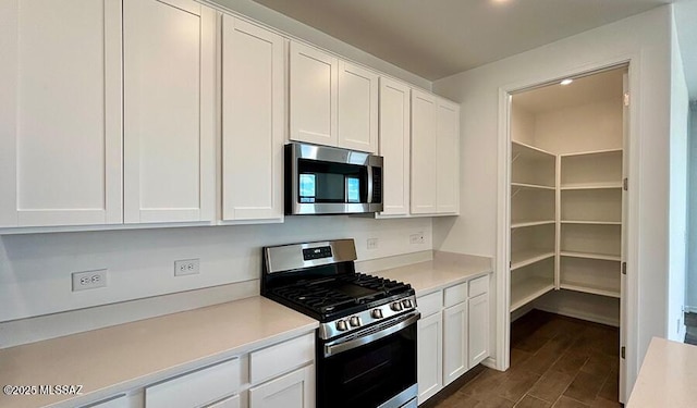 kitchen with light countertops, white cabinetry, and stainless steel appliances