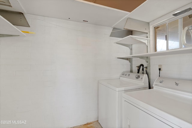 clothes washing area featuring independent washer and dryer