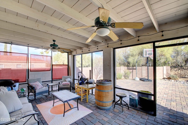 sunroom featuring beam ceiling, wooden ceiling, and ceiling fan