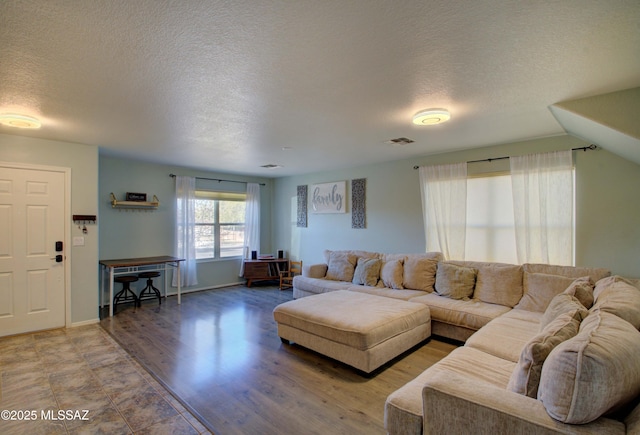 living room with hardwood / wood-style floors and a textured ceiling