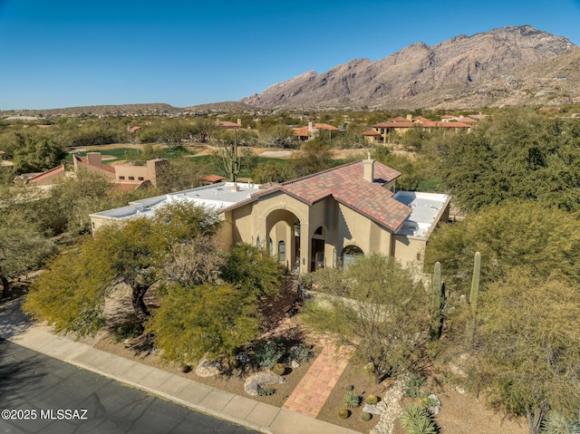 birds eye view of property with a mountain view