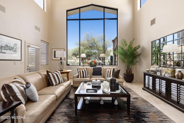 living room featuring a towering ceiling