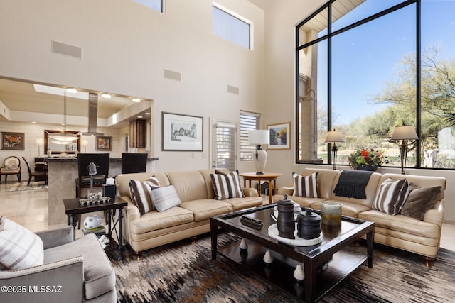 living room featuring a towering ceiling