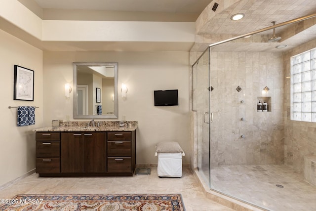 bathroom featuring vanity, tile patterned flooring, and walk in shower