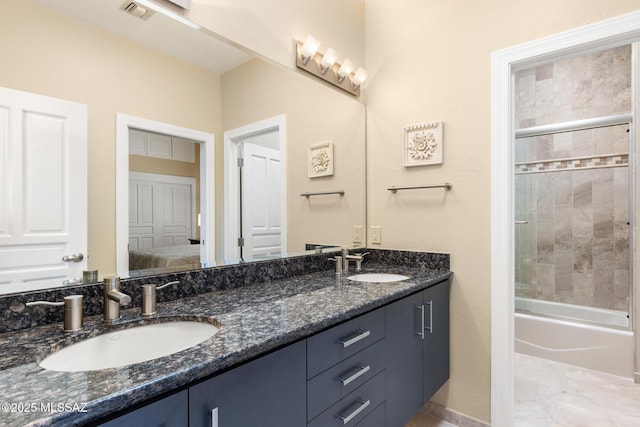 bathroom with vanity and combined bath / shower with glass door