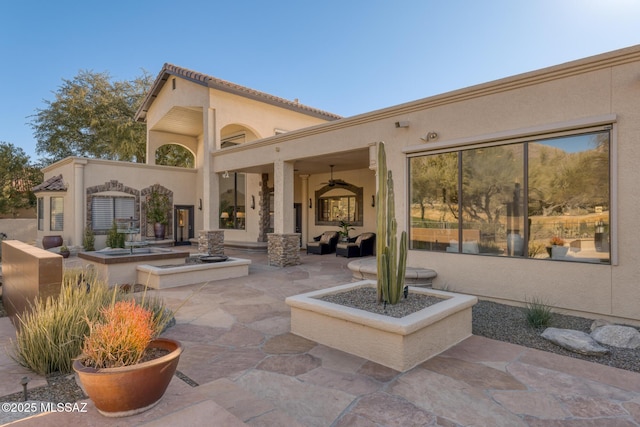 rear view of property featuring a patio area