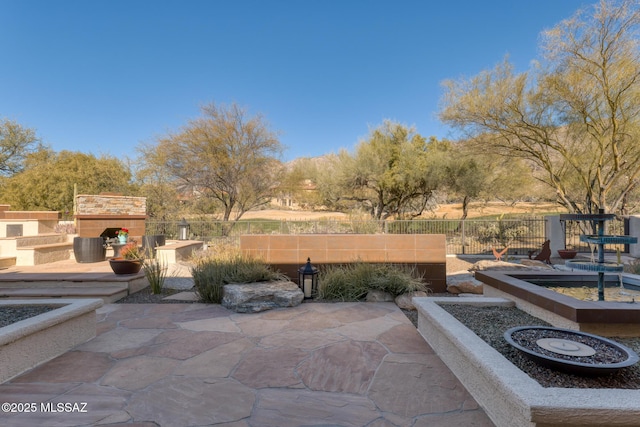 view of patio / terrace featuring an outdoor stone fireplace