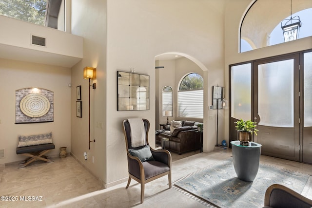 foyer entrance featuring a towering ceiling