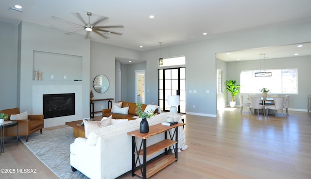 living room featuring ceiling fan and light wood-type flooring