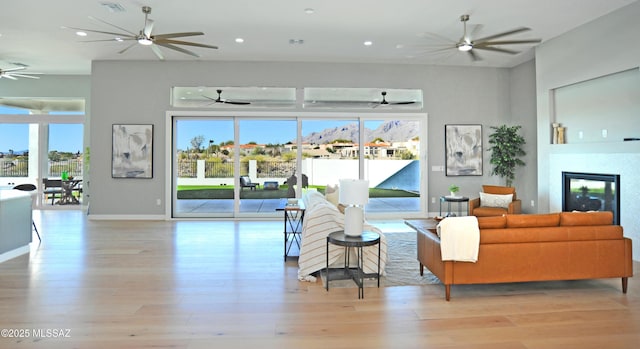 living room with light hardwood / wood-style flooring and a healthy amount of sunlight