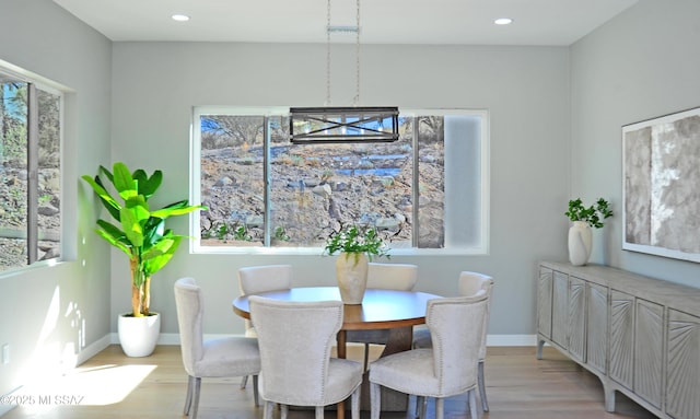 dining room featuring an inviting chandelier and light wood-type flooring