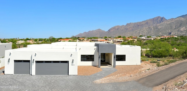 southwest-style home featuring a mountain view and a garage