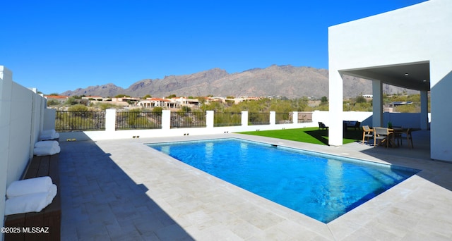 view of pool featuring a mountain view and a patio