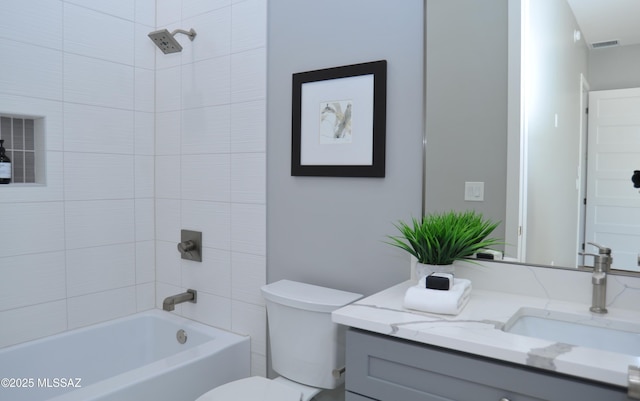 full bathroom with vanity, toilet, and tiled shower / bath