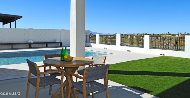 view of swimming pool with a yard and a patio