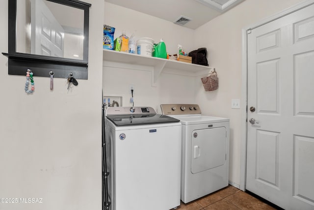 washroom with washing machine and dryer and light tile patterned floors