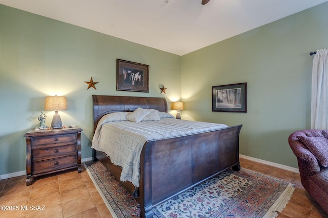 bedroom featuring light tile patterned floors and baseboards