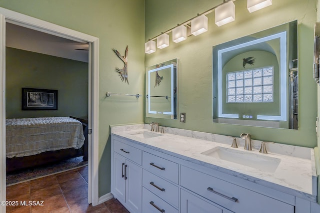 bathroom with double vanity, tile patterned flooring, ensuite bath, and a sink