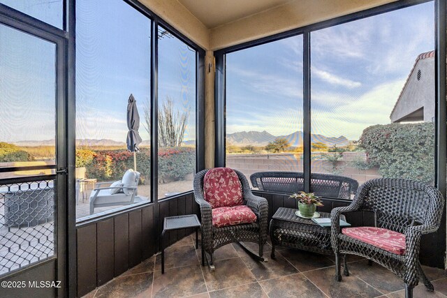 sunroom featuring a healthy amount of sunlight and a mountain view