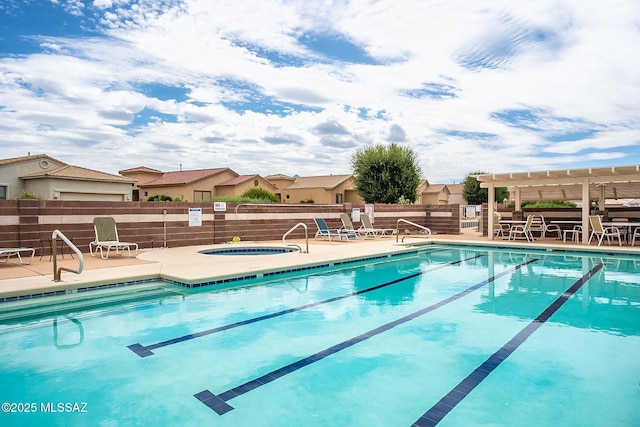 pool featuring a residential view, fence, a hot tub, and a pergola