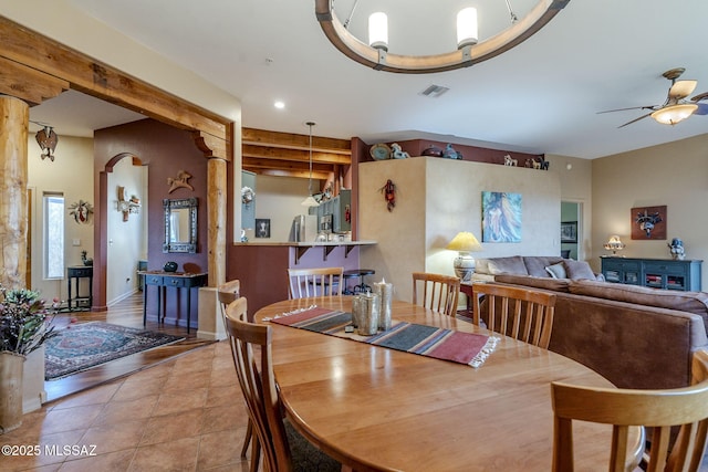 dining room with ceiling fan, light tile patterned floors, beam ceiling, and visible vents